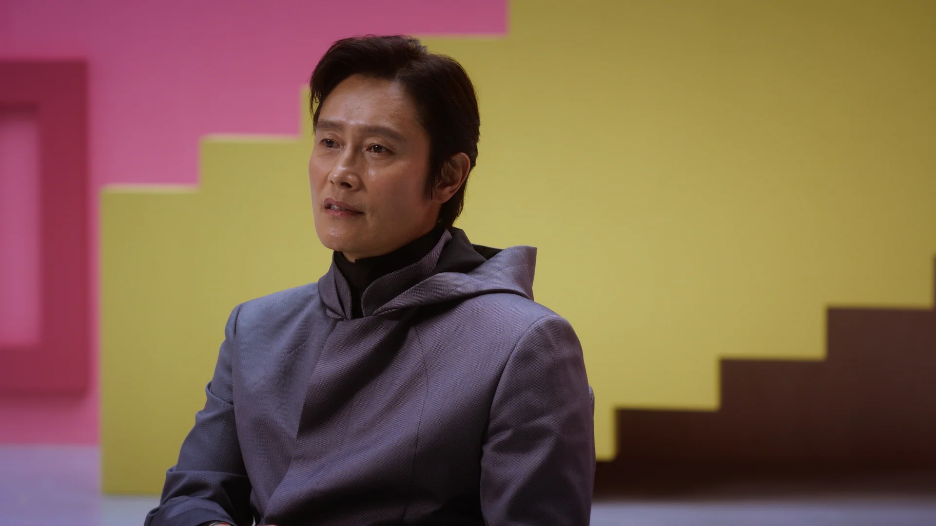 Inside Squid Game S2 — Lee Byung-hun interviewed beside the yellow stairs