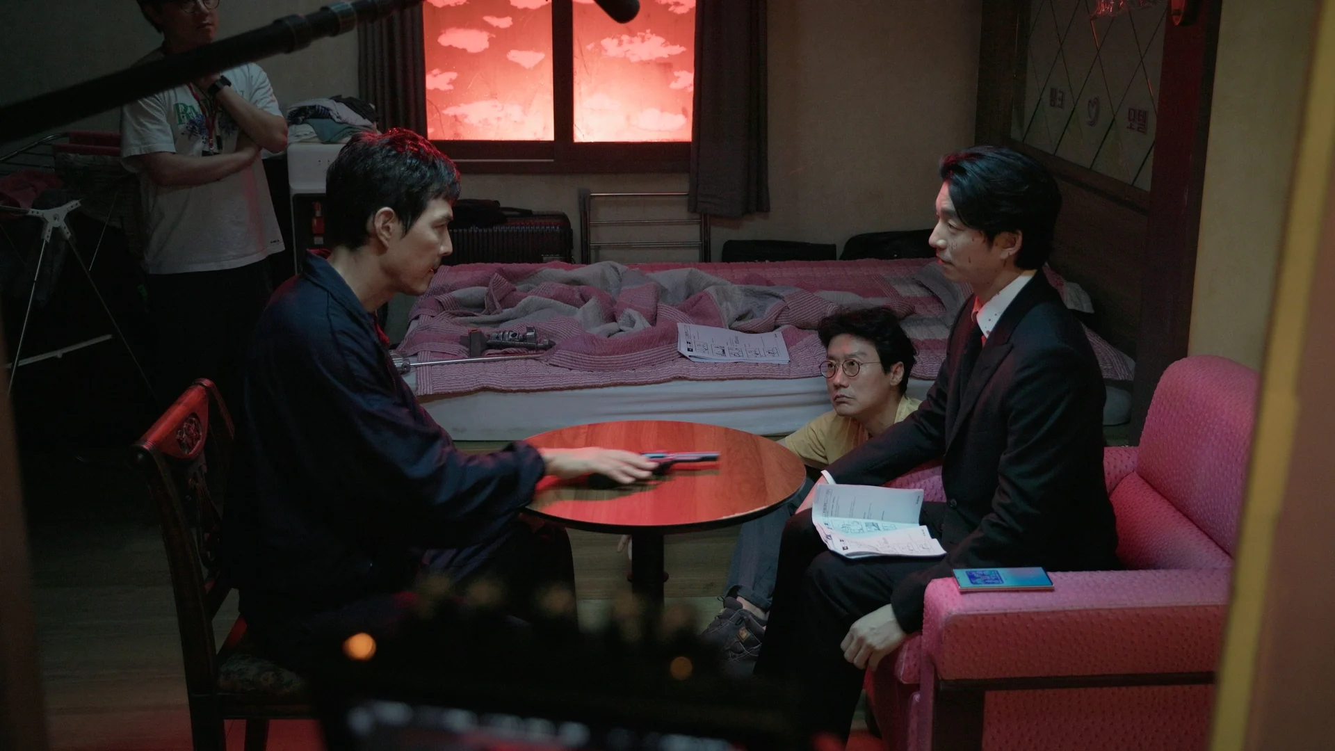 Inside Squid Game S2 — crew filming the recruiter scene in the red-lit subway set